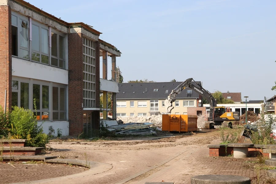 Das Hauptgebäude von der Seite und ein Bagger bei der Arbeit